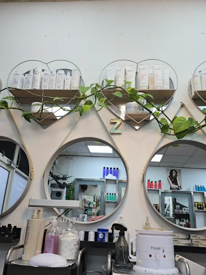 Circular mirrors, plants and professional beauty products at Naz Hair and Beauty