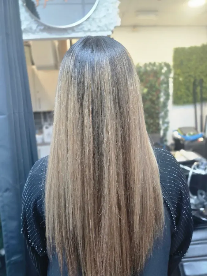 Long dimensional blonde hair result created at Naz Hair and Beauty