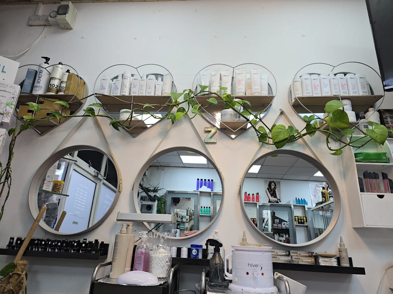 Professional products and circular mirrors inside the salon